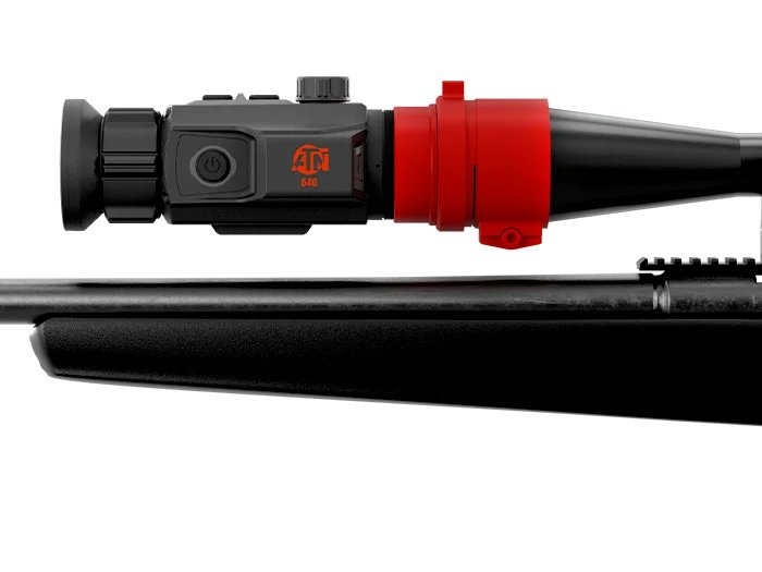 Close-up of the ATN TICO 6 thermal clip-on mounted on a rifle's Picatinny rail ahead of a day scope
