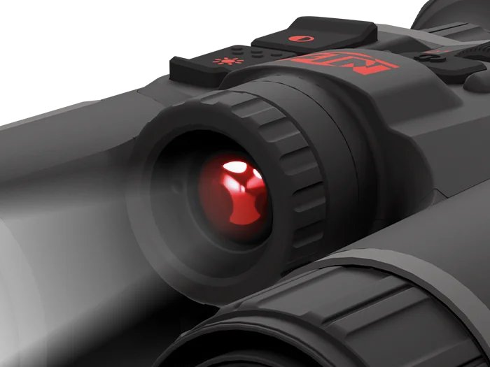 Close-up of an active infrared illuminator on an ATN device emitting a visible red glow and beam of light