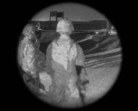 Simulated view through the ATN PS31-3HFW white phosphor night vision goggle showing two operators in low light